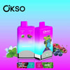 Zwei leuchtende Okso-Vape-Geräte mit doppeltem Geschmack und einem rosa und blauen Farbverlaufsdesign mit Bildern von Minzblättern und gemischten Beeren zur Darstellung der Aromen von Minze und Blue Razz Cherry Cranberry sowie einer Cartoon-Tierillustration und umgebenden Fruchtbildern auf einem Hintergrund mit Farbverlauf.