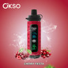 Dispositivo elettronico Okso rosso con display digitale, circondato da ciliegie e schizzi d’acqua, etichettato 'Cherry Fiesta'.