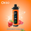 Dispositivo elettronico Okso arancione con display digitale, circondato da schizzi d’acqua, una fragola e fette di anguria, su sfondo arancione con scritta 'Strawberry Watermelon'.