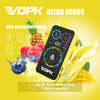 Vopk Ultra 40000 Vape Device With A Digital Display, Surrounded By Splashes Of Yellow Liquid, Pineapples, Mangoes, Raspberries, And Blueberries, Highlighting Dual Flavor Switching For Blue Razz Pineapple And Triple Mango.