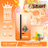 Bang Blaze Joycome Disposable Vape Device With A Skull Wearing A Crown Design, Featuring Pineapple Mango And Pineapple Coconut Ice Flavors, And Details About 40Ml Volume, 650Mah Battery, And 4000 Puffs, Set Against An Orange Background With Fruit Illustrations.