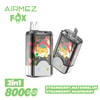 Werbebild für Airmez-Fox-Vape mit zwei Vape-Geräten mit einer farbenfrohen Fox-Illustration, die 2-in-1-Aromen (Erdbeer-Wassermelon- und Erdbeer-Himbeer) und 8000 Puffs hervorhebt, die vor einem lebendigen, geometrischen Hintergrund eingestellt sind.