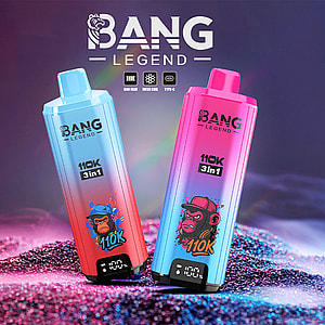 Two colorful BANG LEGEND 3-in-1 vape devices with gradient blue and pink designs, each featuring a stylized cartoon monkey illustration and digital display, standing on glittery sand under neon lighting.