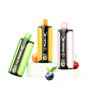 Three Stagbar disposable vapes with LED displays in green, yellow, and pink, surrounded by fresh peach, blueberry, and cherry on a white display block.