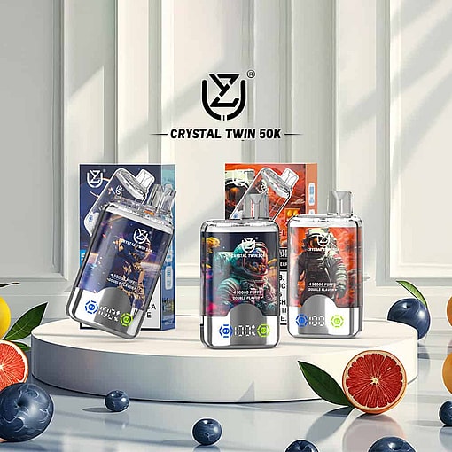 Display Of Crystal Twin 50K Vape Devices And Packaging With Astronaut-Themed Graphics, Surrounded By Fruit Including Grapefruit Slices, Blueberries, And Oranges In A Bright, Modern Setting.