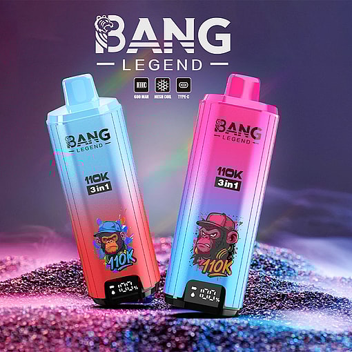 Two Colorful Bang Legend 3-In-1 Vape Devices With Gradient Blue And Pink Designs, Each Featuring A Stylized Cartoon Monkey Illustration And Digital Display, Standing On Glittery Sand Under Neon Lighting.