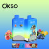 Two Blue Okso Double Flavor Vape Devices With Flavor Options Apple Peach And Blue Razz Lemonade, Fruit Images, And A Cartoon Ape Illustration, Set Against A Gradient Background With Floating Fruits And Branding.