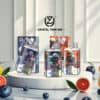 Display van Crystal Twin 50K vape-apparaten en verpakkingen met afbeeldingen met astronaut-thema, omringd door fruit, waaronder plakjes grapefruit, bosbessen en sinaasappels in een heldere, moderne setting.