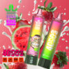Twee kleurrijke Bang King Vape -apparaten met aardbei- en watermeloensmaken, omgeven door aardbeien, watermeloenplakken en spatten van melk op een roze achtergrond, met productkenmerken gemarkeerd.