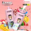Bang Legend 3-in-1 vape-apparaat met een cartoonaap die een koptelefoon op het etiket draagt, omgeven door afbeeldingen van watermeloen, mango, perzik, sinaasappel en ijs, het promoten van watermeloenijs, mango-perzik en oranje frisdranke smaken.
