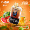 Bang Leader Stoll Vaping Device With A Gorilla Logo, Placed In Front Of Watermelon, Strawberry, And A Glass Of Orange Soda, Highlighting The Strawberry Watermelon And Orange Soda Flavors.