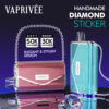 Promotional Image For Vaprivée Featuring Two Electronic Devices Decorated With Rhinestones, One Pink Shaped Like A Purse And One Blue, Both With Chains, Highlighting Their Handmade Diamond Sticker Design, Puff Quantities, And Elegant Style.