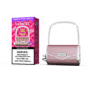 Vaprivée White Peach Raspberry Flavored Vape In A Purse-Shaped, Pink And Silver Device With A Chain Handle, Displayed Next To Its Stylish Pink Packaging And A Nicotine Warning Label.